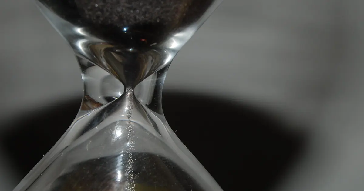 Sand running through an hourglass