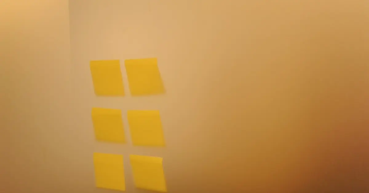 Square sticky notes spaced out on a wall